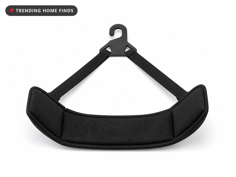Black padded fabric neck cradle with two flat webbing straps and a moulded door anchor, laid flat.
