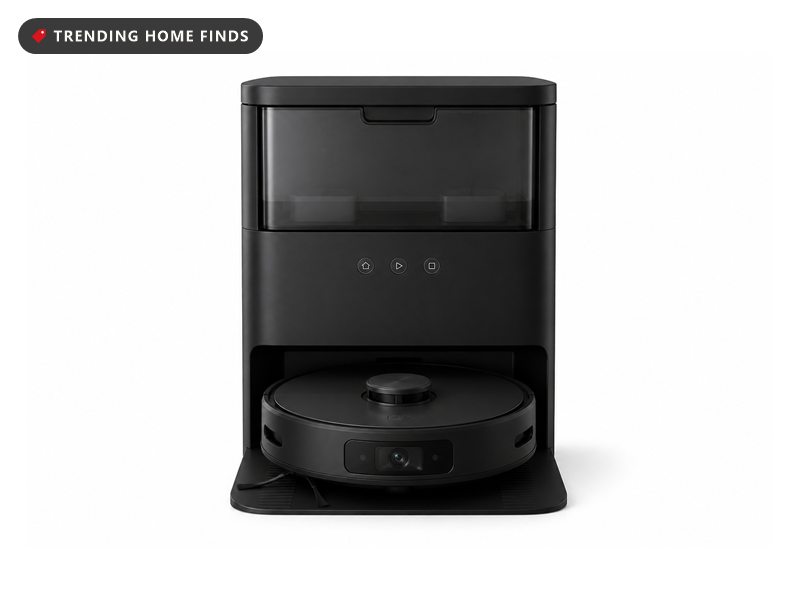 Black Tikom robot vacuum with a raised laser turret, docked in front of its tall self-emptying base station