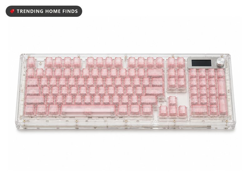 Clear-cased keyboard glowing on an aesthetic desk setup under flat overcast daylight, small screen looping an animation, knob at the top right.
