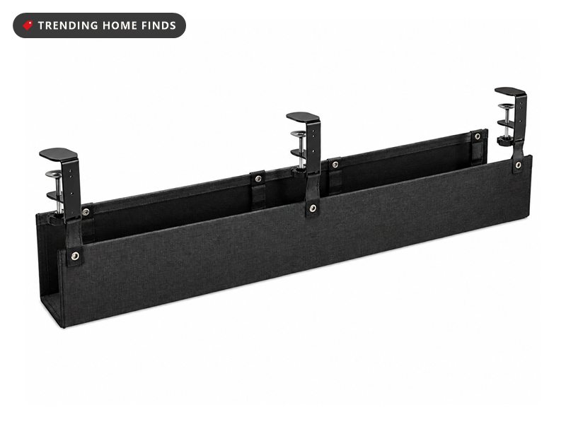 Long black fabric under desk cable management tray held by three adjustable screw clamps along its back edge