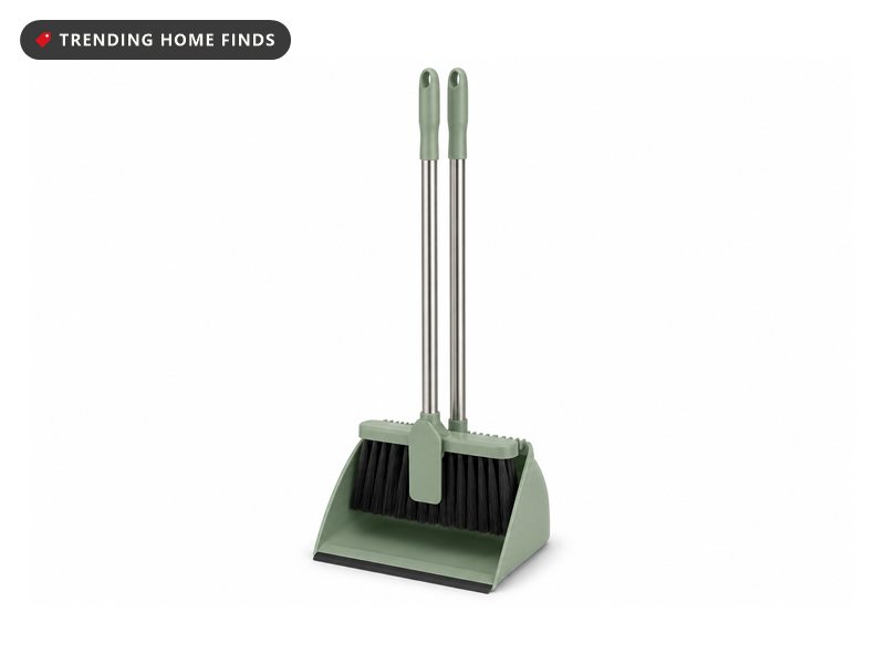 A sage green upright broom clipped into its matching dustpan with a long steel pole and black bristles.