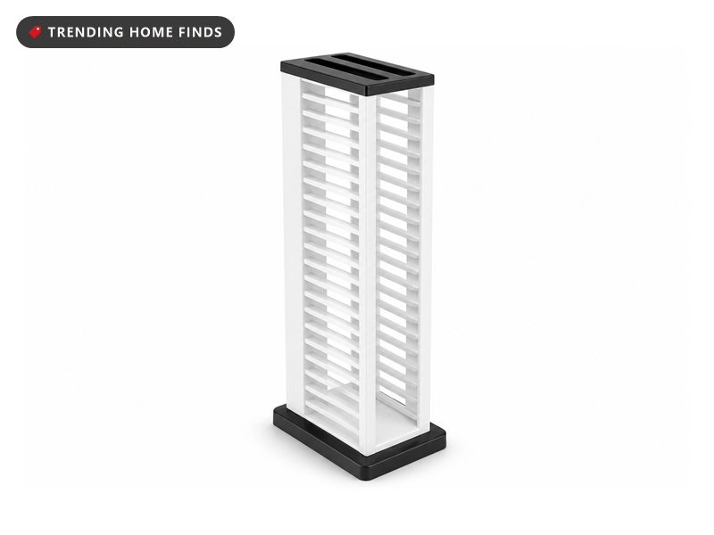 A tall white and black vertical game storage column with rows of narrow open slots down both sides.