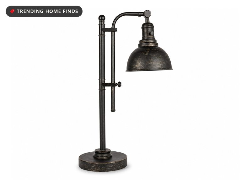 Industrial desk lamp with an aged bronze dome shade on an adjustable dark metal stand