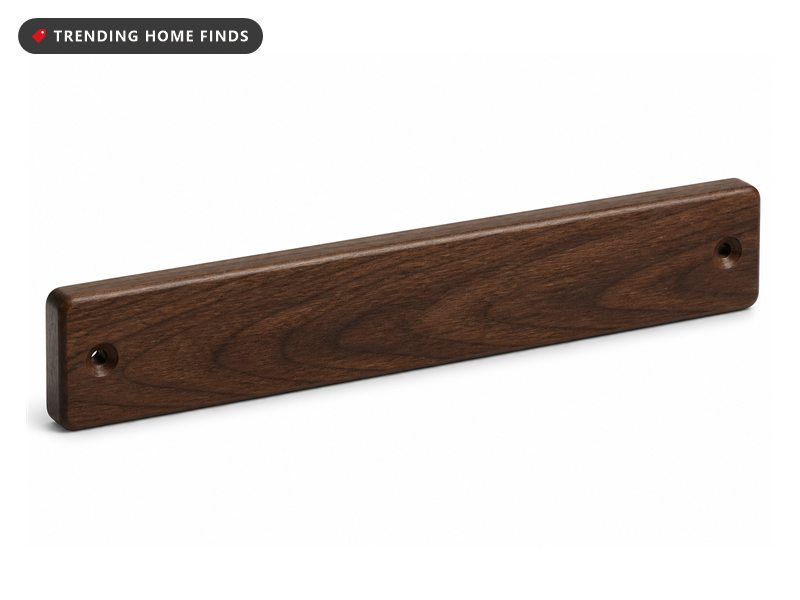Sixteen inch dark walnut magnetic knife strip shown at an angle with its end screw holes visible.