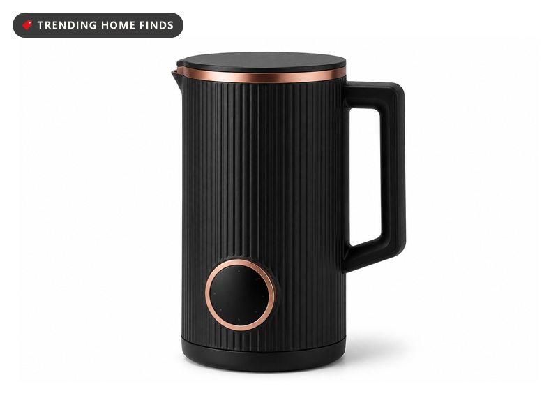 Tall black ribbed countertop milk machine with copper trim rings and a round control panel.
