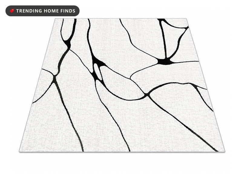 White area rug with a thin black abstract line pattern