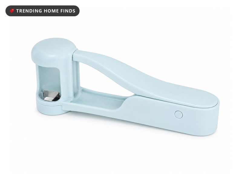 Light blue handheld grape cutter with a stainless blade window that quarters grapes in one press
