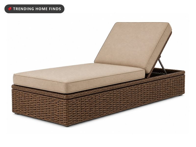 Brown wicker outdoor storage chaise lounge with its lid open showing folded towels inside