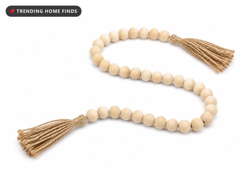 A strand of natural wood beads with jute tassels at both ends.