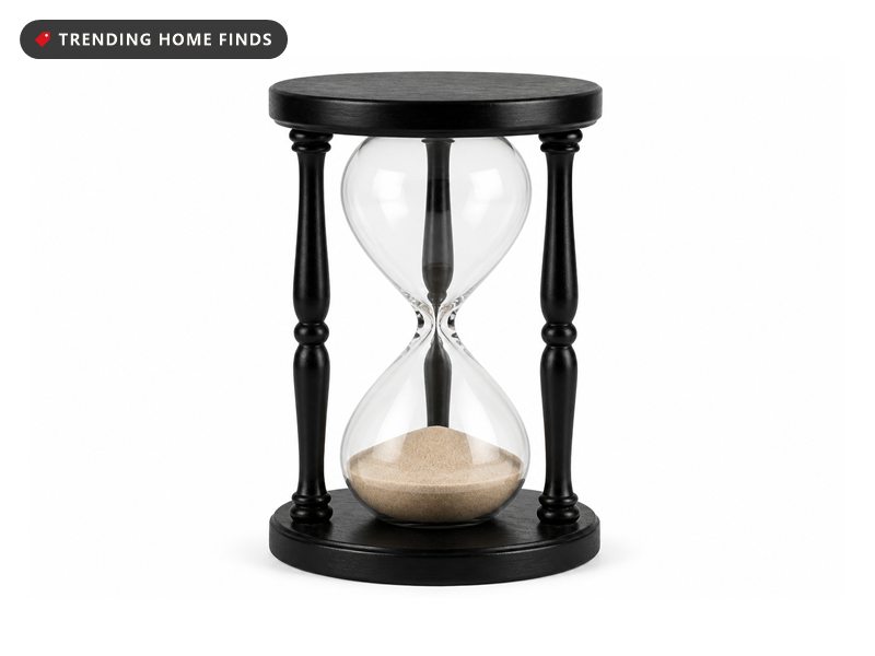 A large hourglass in a black wooden frame.