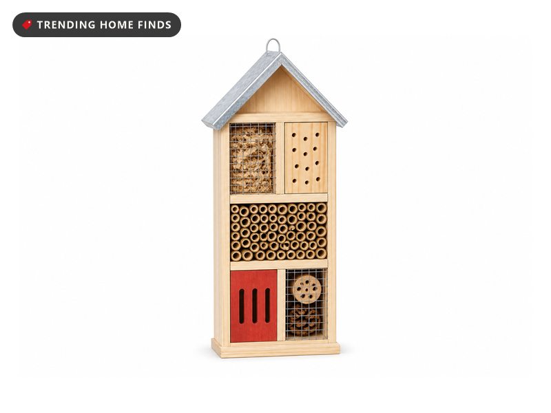 A pale pine insect hotel with a silver metal roof, a row of bamboo tubes and a red slotted panel.