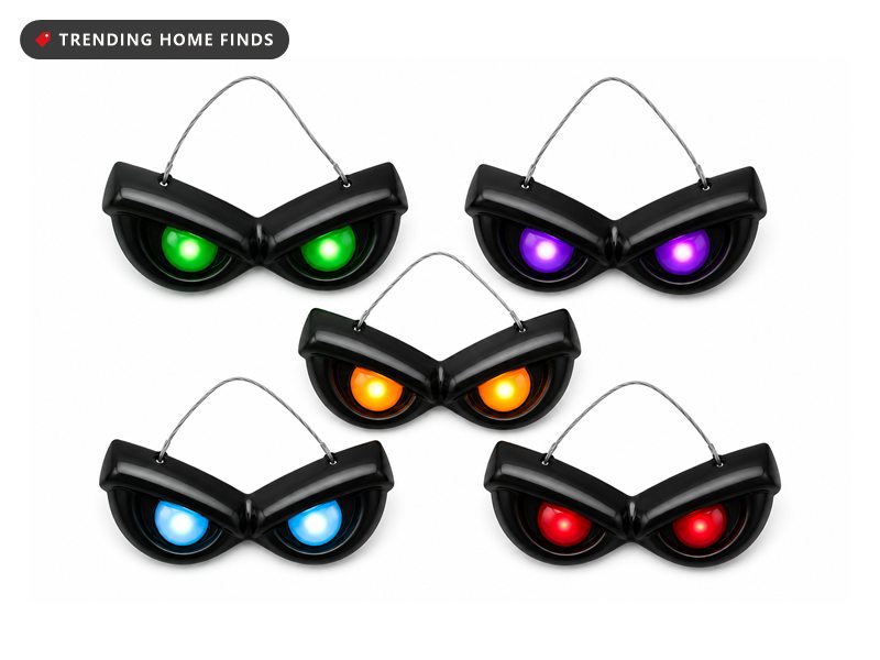 Five pairs of black plastic Halloween eyes with lit colored lenses, hanging on fine wires.
