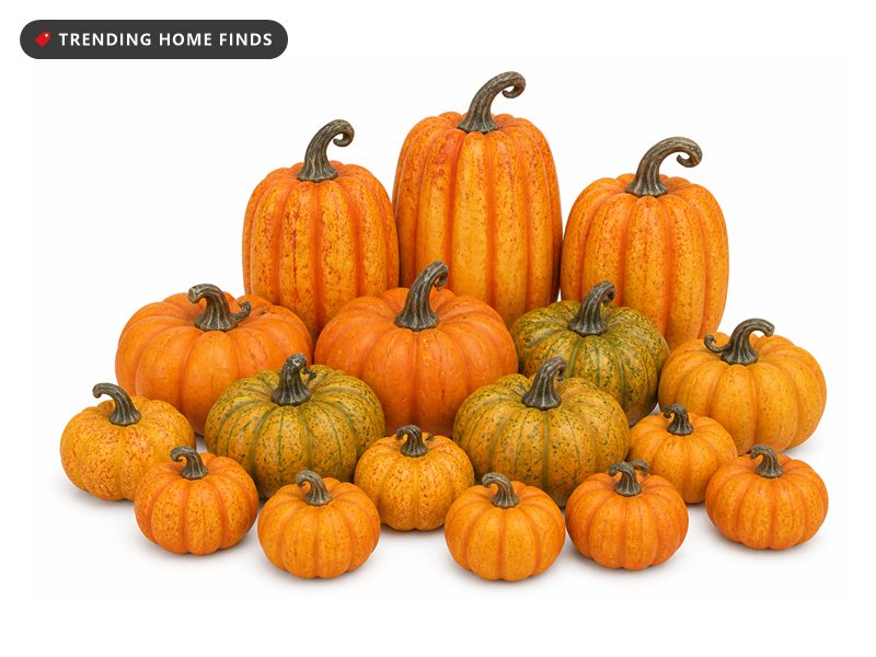 Sixteen orange and mottled green foam pumpkins in mixed sizes grouped together, each with a molded plastic stem.